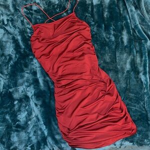 Red coquette dress. Rugged on the sides. Short and cute.